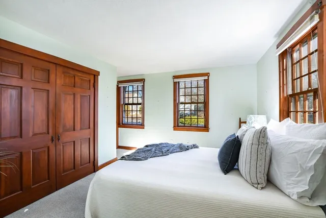 a bedroom with double bed and a chandelier