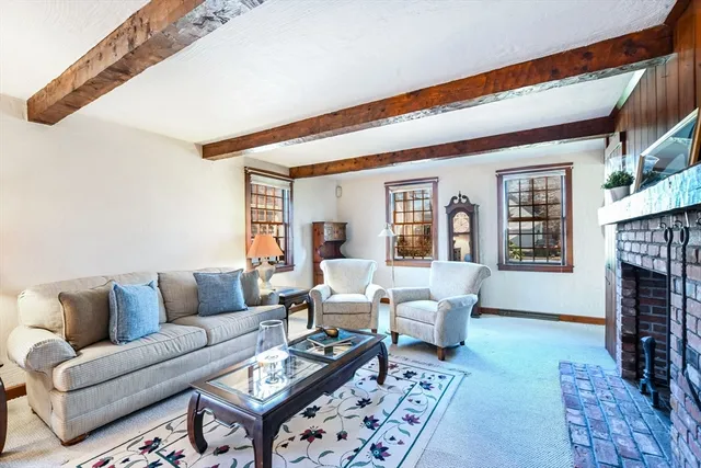 a living room with fireplace furniture and a fireplace