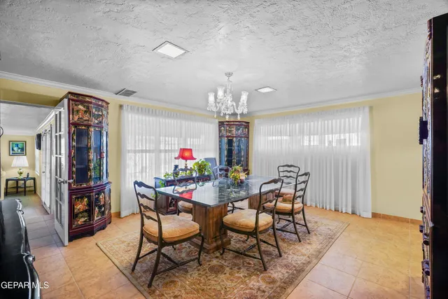 a view of a dining room with furniture and chandelier