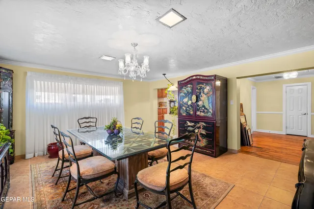 a view of a dining room with furniture and chandelier