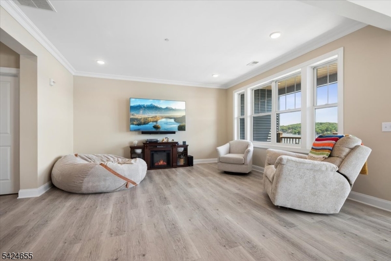 401 Mariners Pointe Hopatcong, NJ 07843 - Photo 11 of 42 a living room with furniture and a large window