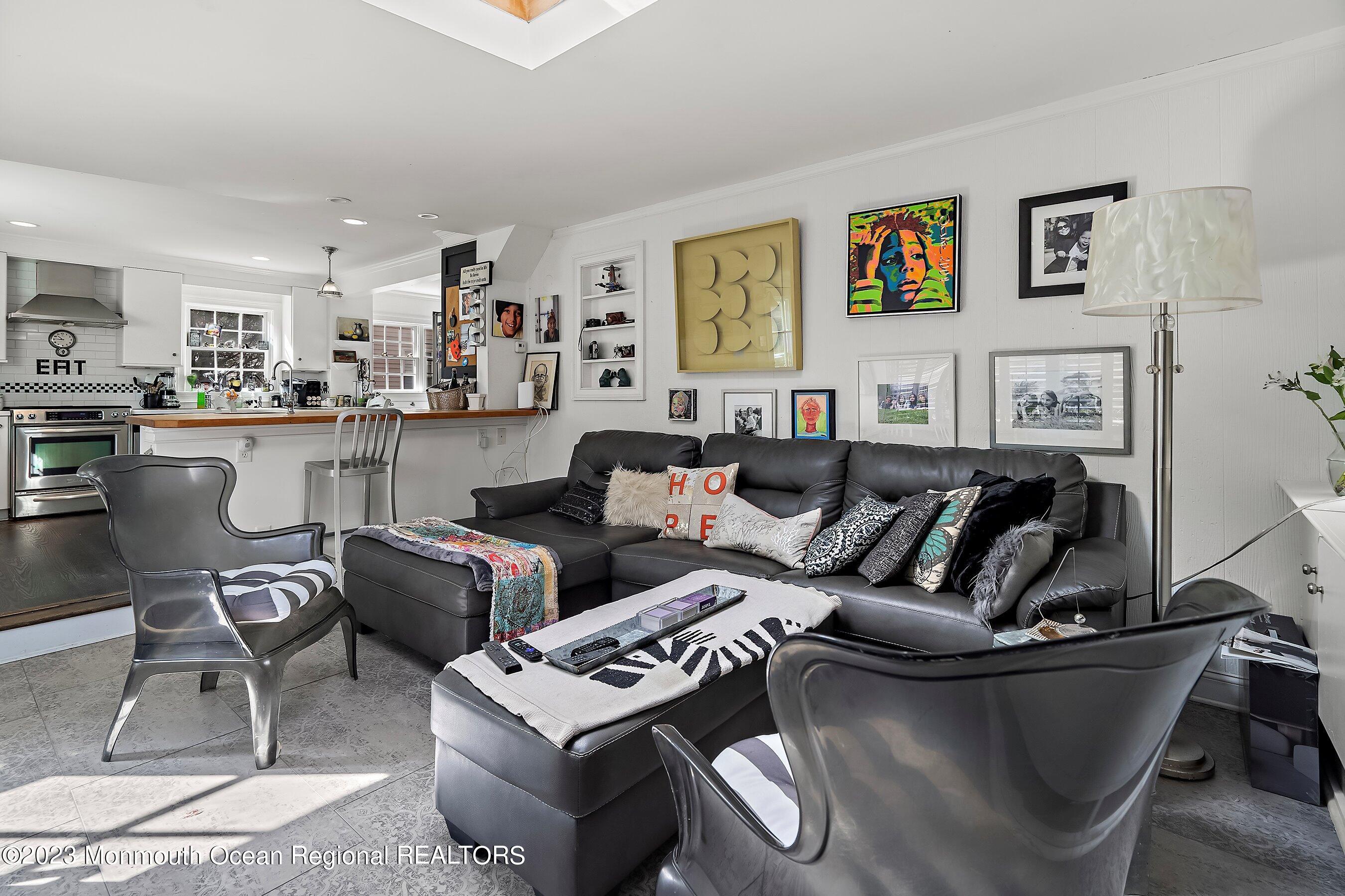 24 St Nicholas Place Red Bank, NJ 07701 - Photo 4 of 11 a living room with furniture and a kitchen view