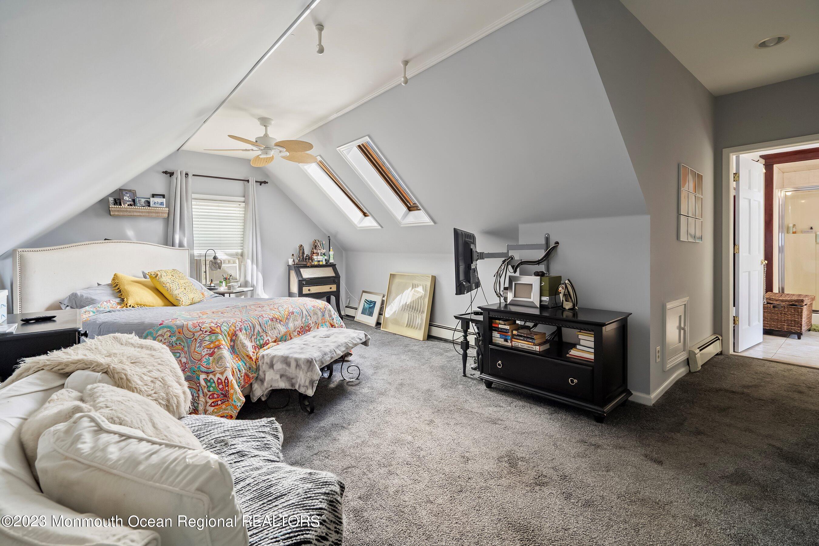 24 St Nicholas Place Red Bank, NJ 07701 - Photo 5 of 11 a spacious bedroom with a bed and a couch