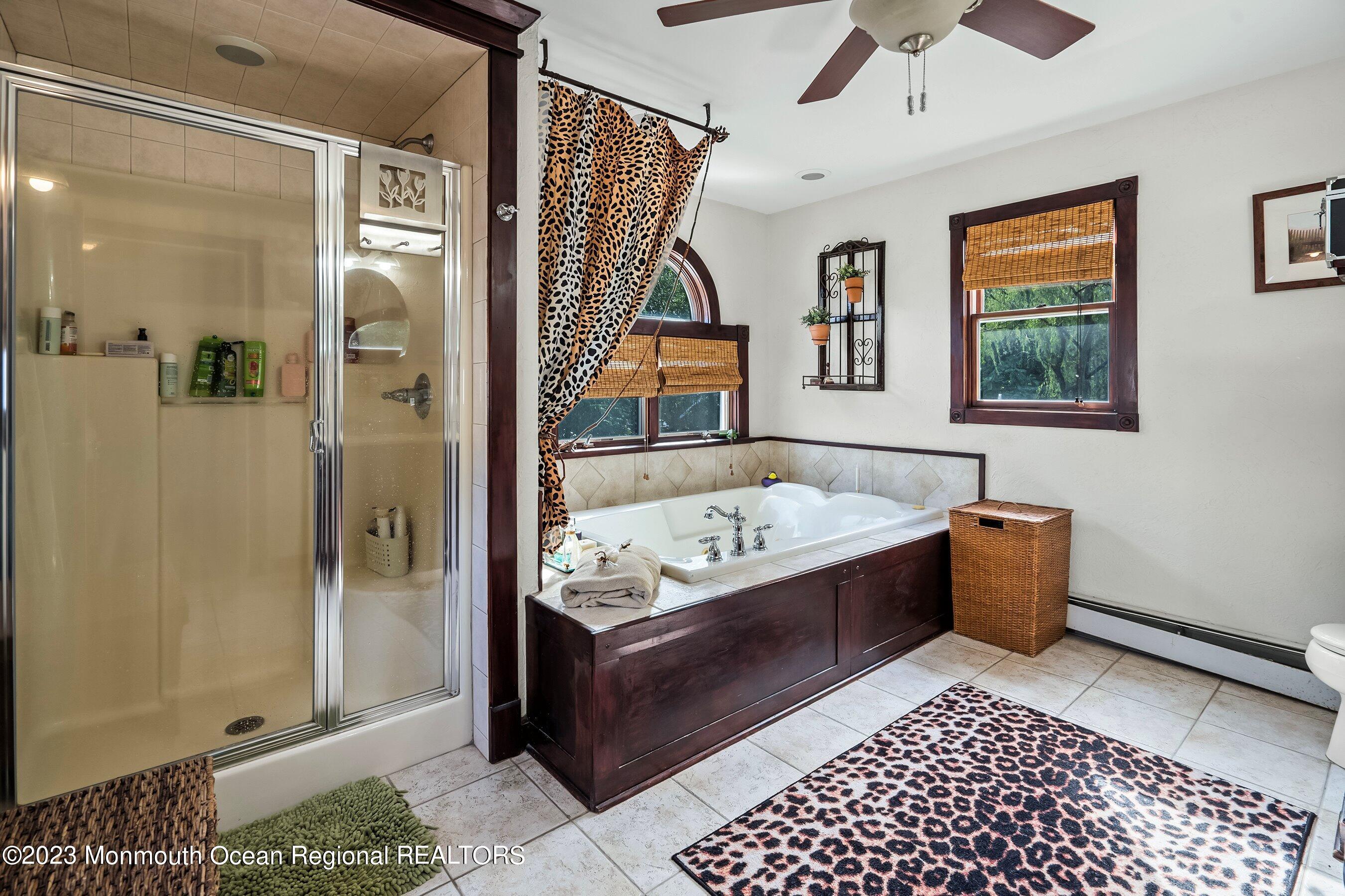 24 St Nicholas Place Red Bank, NJ 07701 - Photo 6 of 11 a bathroom with a tub shower and window