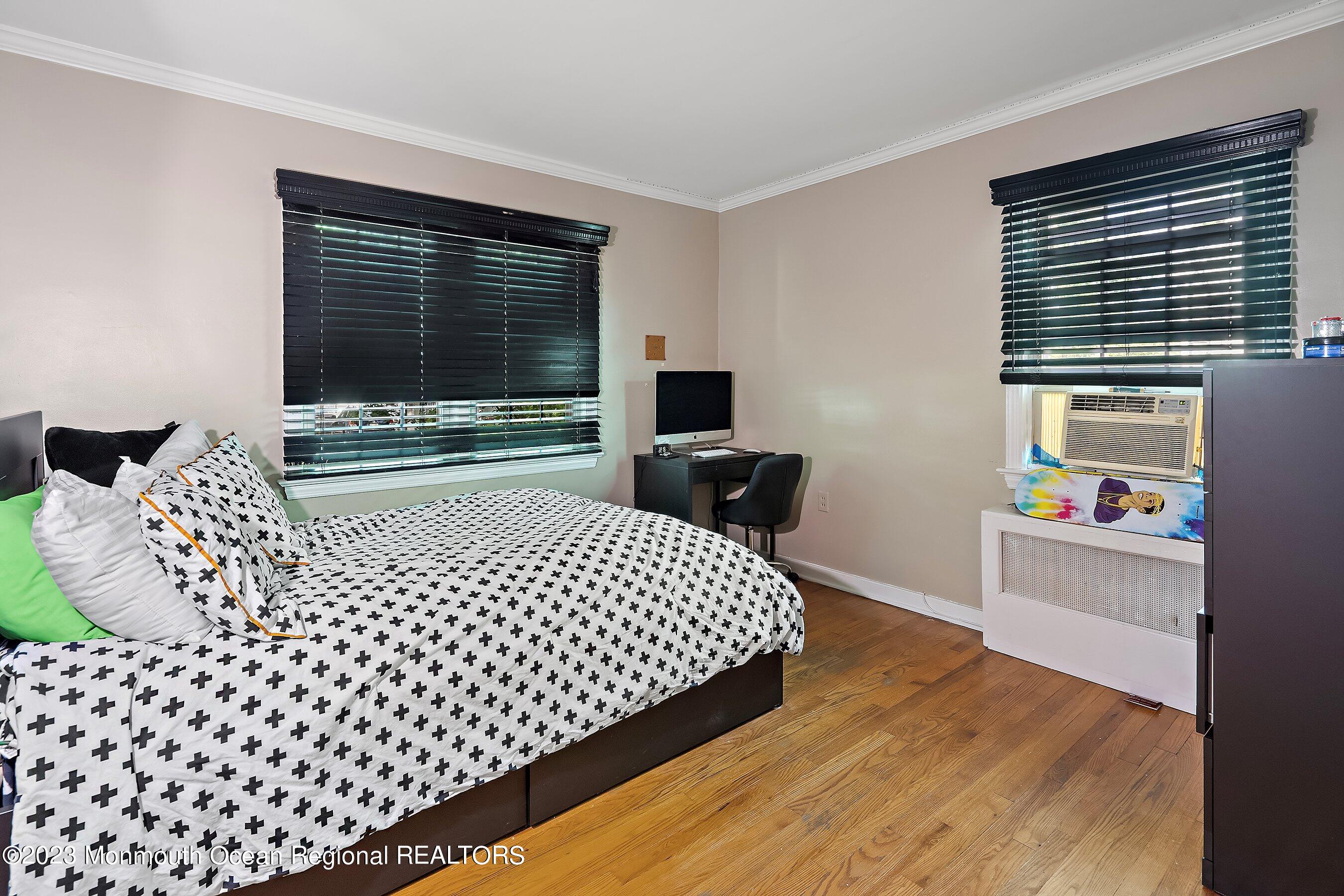 24 St Nicholas Place Red Bank, NJ 07701 - Photo 7 of 11 a bedroom with a bed and a flat screen tv
