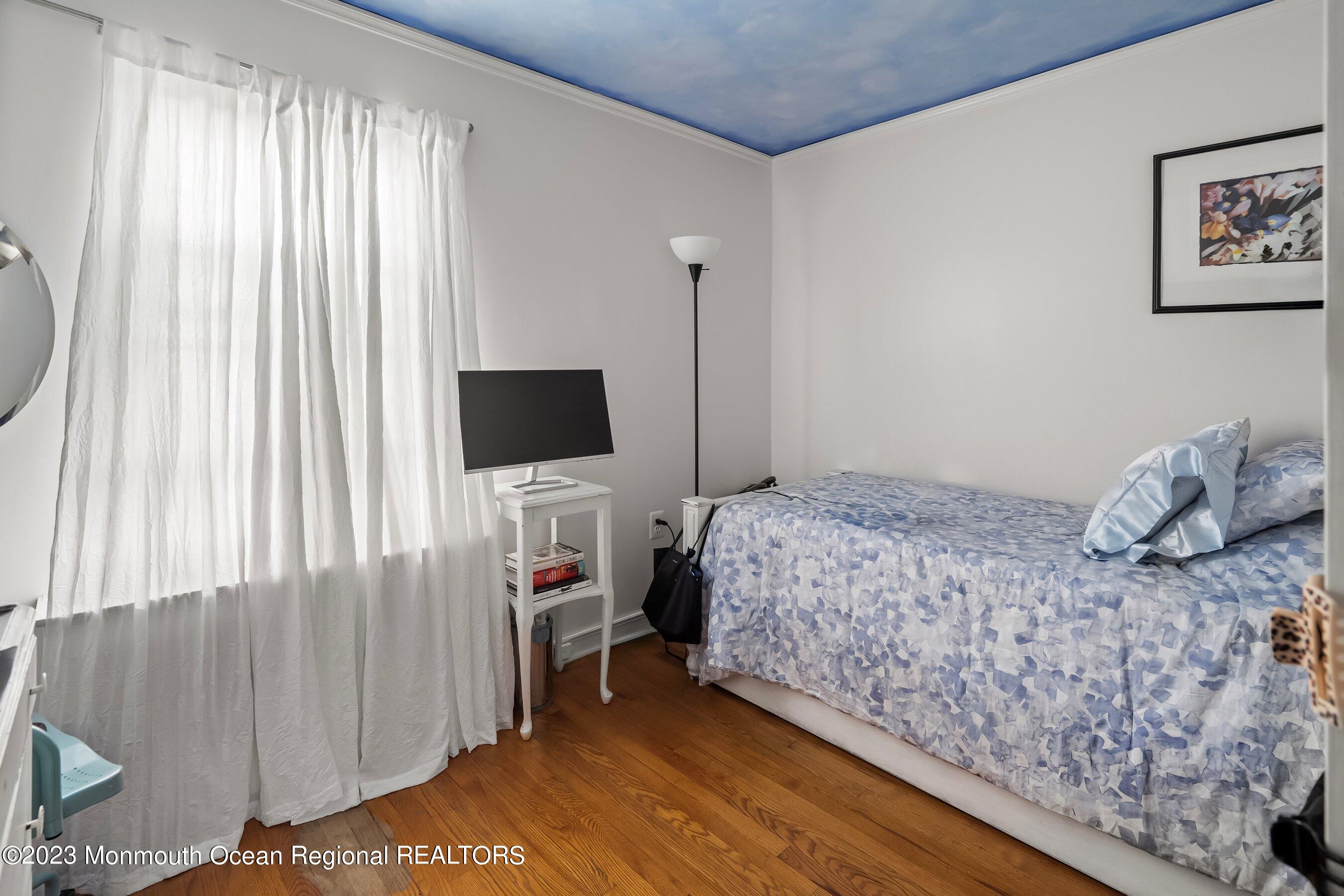24 St Nicholas Place Red Bank, NJ 07701 - Photo 8 of 11 a bedroom with a bed and a flat screen tv