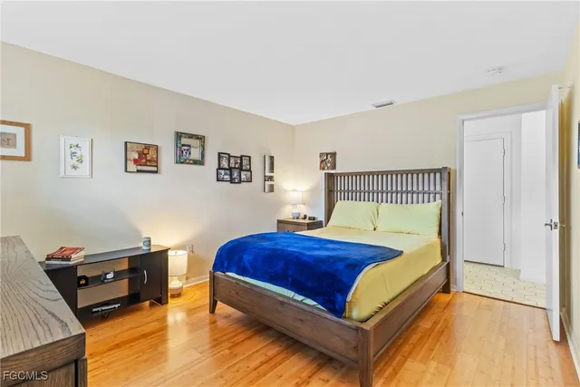 a bedroom with a bed a dresser and a couch