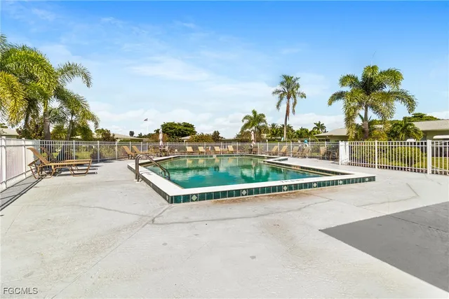 a view of swimming pool with outdoor seating and plants