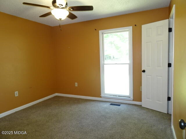 981 Santa Fe Trail Macon, GA 31220 - Photo 14 of 17 an empty room with a window and a fan