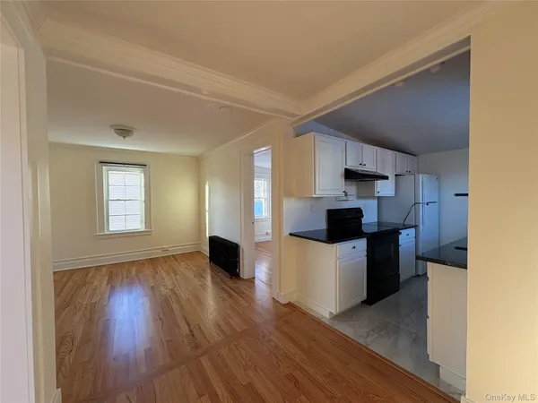 a kitchen with a refrigerator and a stove top oven