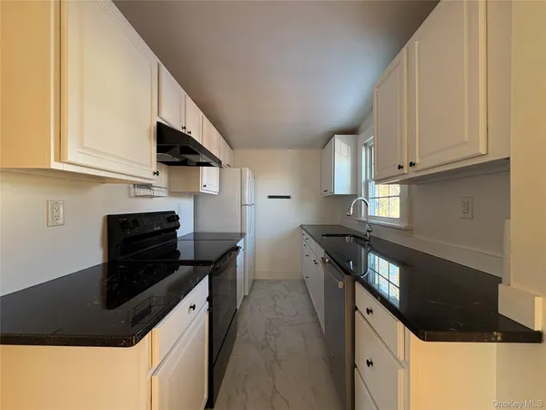 a kitchen with a sink and an oven