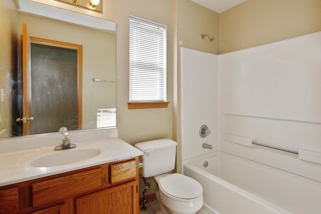 2213 Carpenter Avenue Plainfield, IL 60586 - Photo 12 of 25 a bathroom with a sink toilet vanity and tub