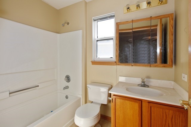 2213 Carpenter Avenue Plainfield, IL 60586 - Photo 17 of 25 a bathroom with a sink toilet and shower