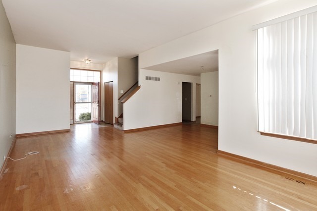 2213 Carpenter Avenue Plainfield, IL 60586 - Photo 18 of 25 a view of a livingroom with wooden floor and windows