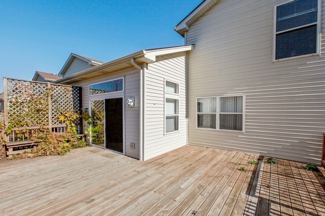 2213 Carpenter Avenue Plainfield, IL 60586 - Photo 20 of 25 a view of a house with a wooden deck
