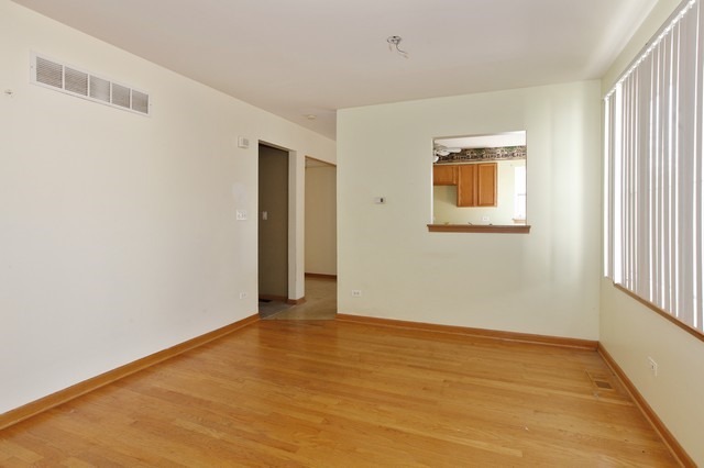 2213 Carpenter Avenue Plainfield, IL 60586 - Photo 6 of 25 a view of an empty room with wooden floor and a window