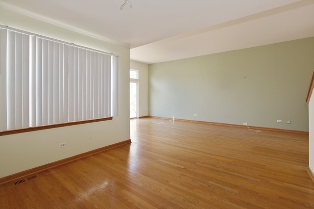 2213 Carpenter Avenue Plainfield, IL 60586 - Photo 7 of 25 a view of an empty room with wooden floor