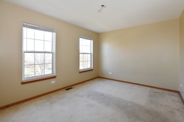 2213 Carpenter Avenue Plainfield, IL 60586 - Photo 10 of 25 an empty room with windows