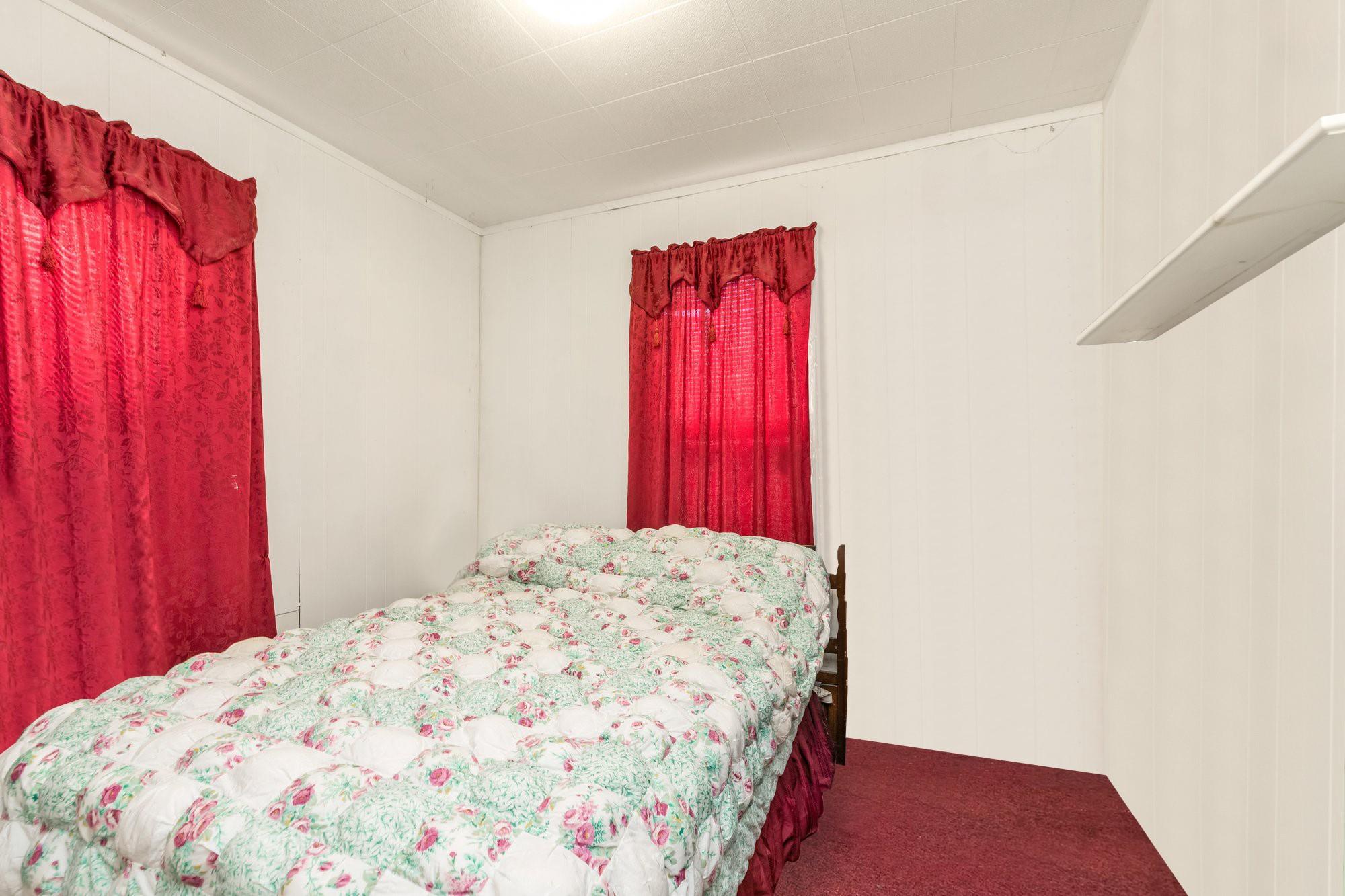 112-50 38th Avenue Queens, NY 11368 - Photo 14 of 17 a bedroom with a bed and a window