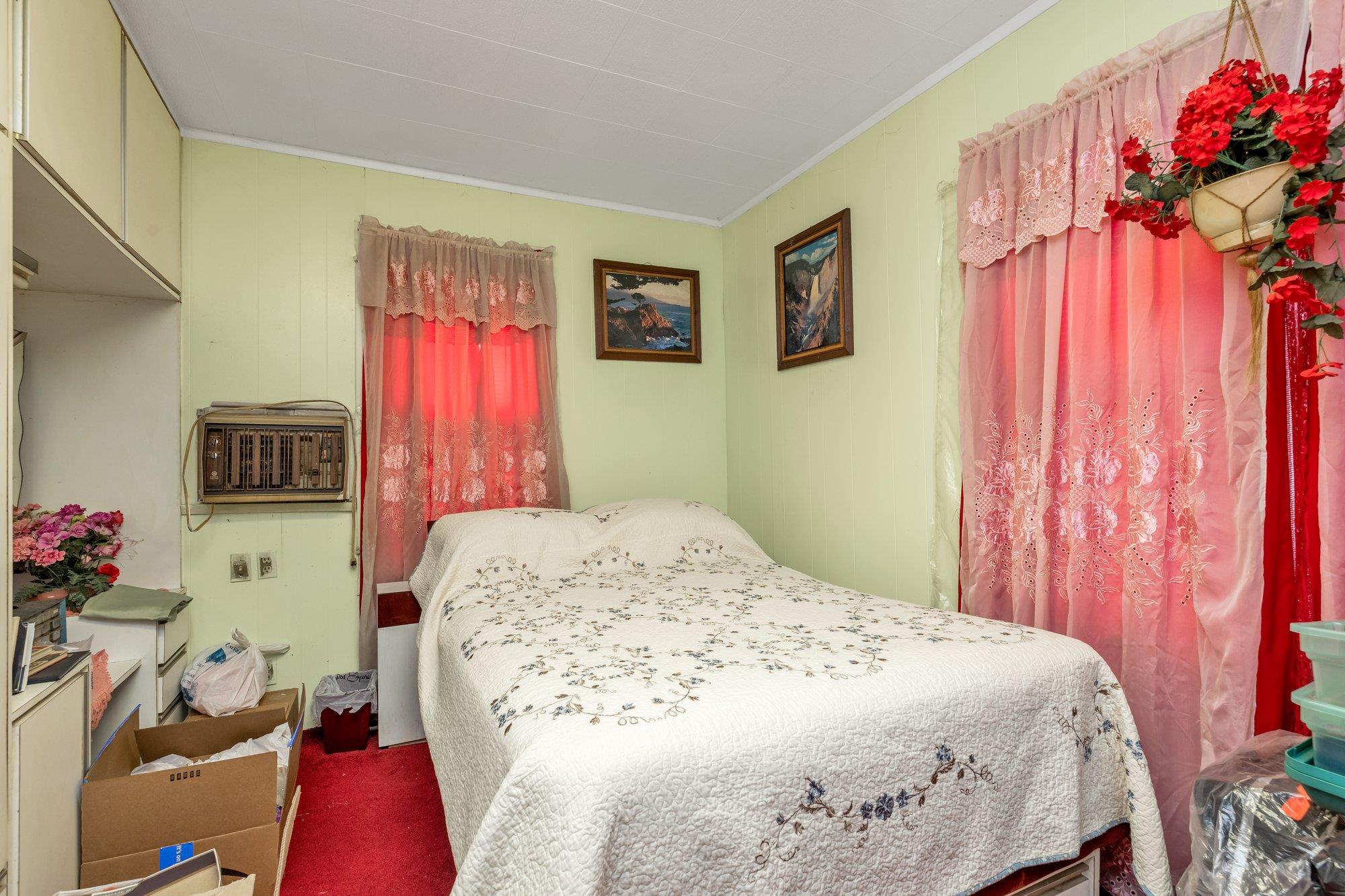 112-50 38th Avenue Queens, NY 11368 - Photo 15 of 17 a bedroom with a bed and a window