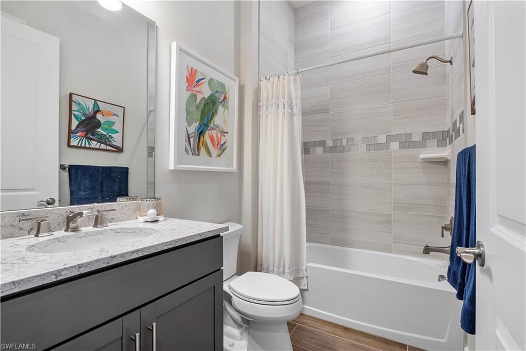 20150 Napa Loop Estero, FL 33928 - Photo 32 of 49 Full bathroom with shower / bath combo with shower curtain, oversized vanity, and toilet