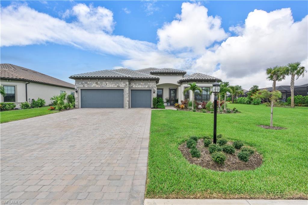 20150 Napa Loop Estero, FL 33928 - Photo 40 of 49 View of front of house with a garage and a front yard