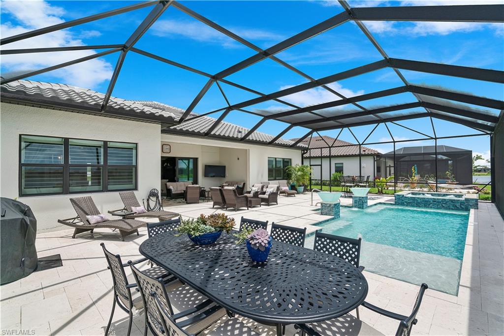 20150 Napa Loop Estero, FL 33928 - Photo 6 of 49 View of swimming pool with outdoor lounge area, an in ground hot tub, glass enclosure, and a patio area