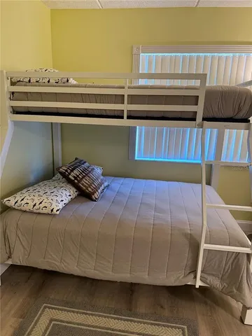 a bed sitting in a bedroom next to a cabinet