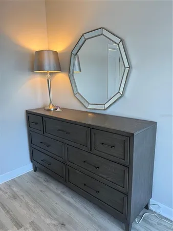 a room with a mirror and lamp