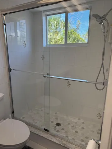 a bathroom with a shower and toilet