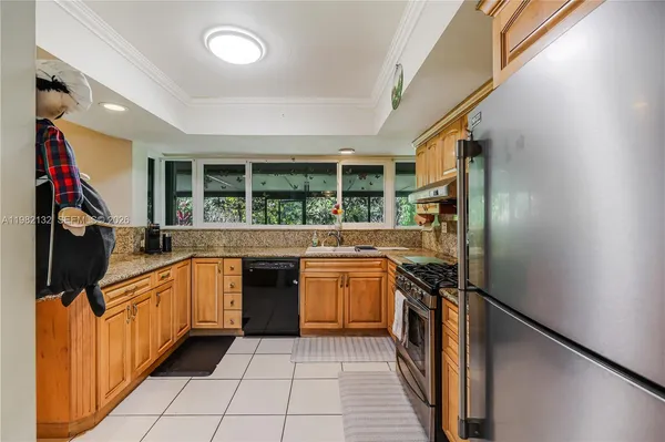 a kitchen with stainless steel appliances granite countertop a sink and a stove
