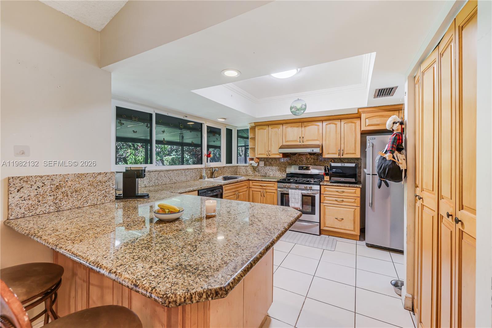 11541 Southwest 100th Street Miami, FL 33176 - Photo 12 of 51 a kitchen with stainless steel appliances granite countertop a sink refrigerator and cabinets