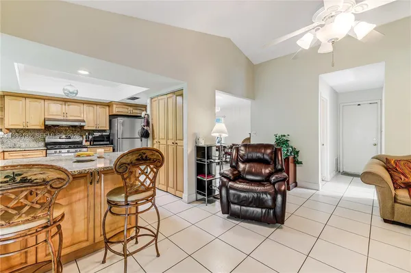 a living room with furniture and kitchen view