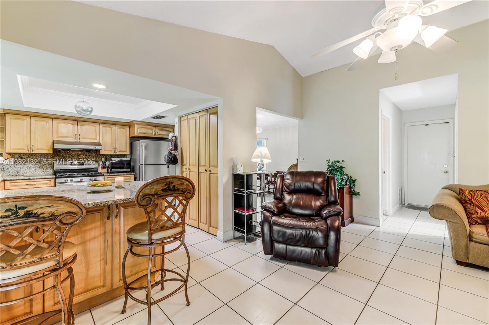 11541 Southwest 100th Street Miami, FL 33176 - Photo 13 of 51 a living room with furniture and kitchen view