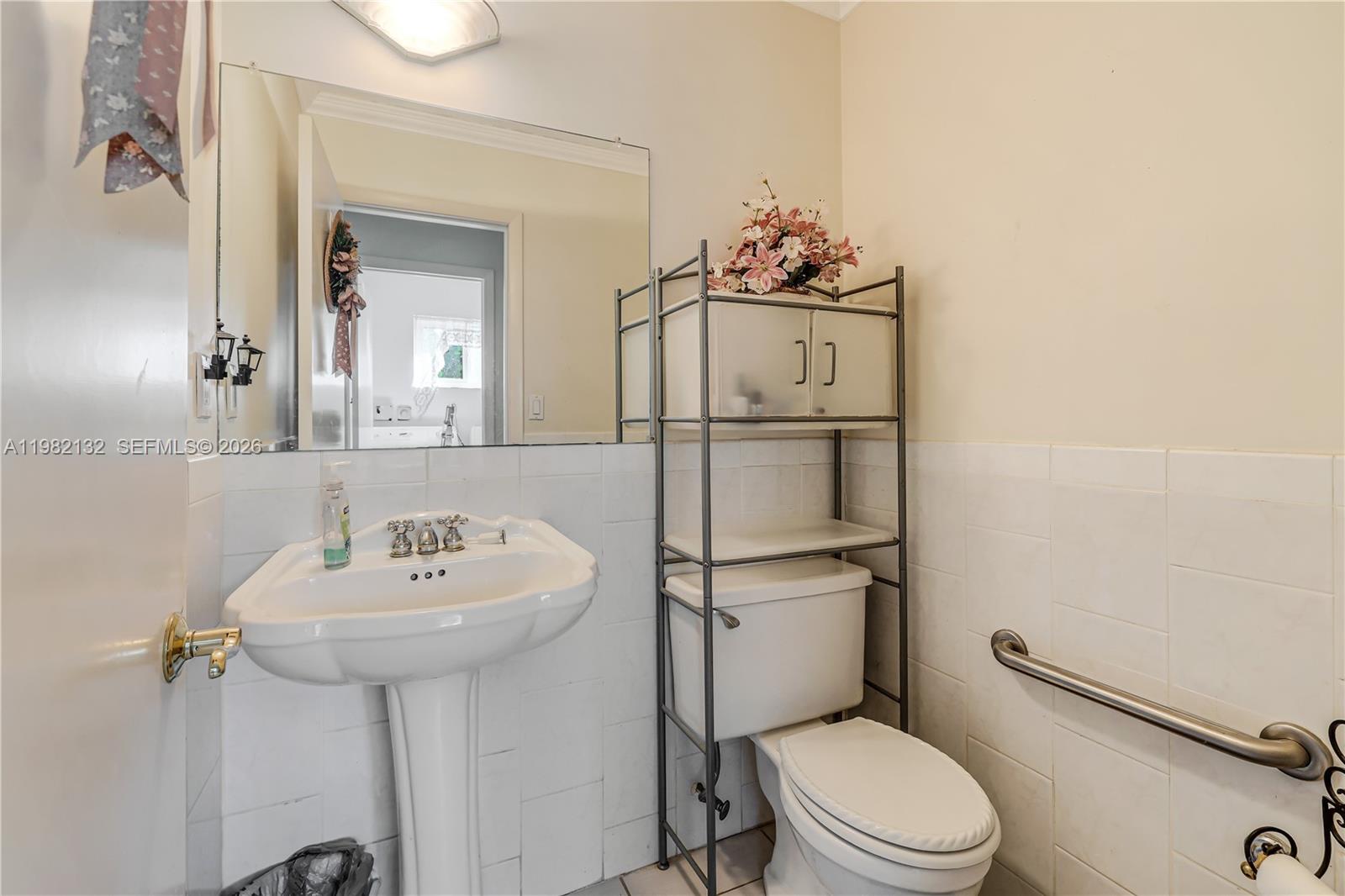 11541 Southwest 100th Street Miami, FL 33176 - Photo 14 of 51 a bathroom with a toilet sink and mirror