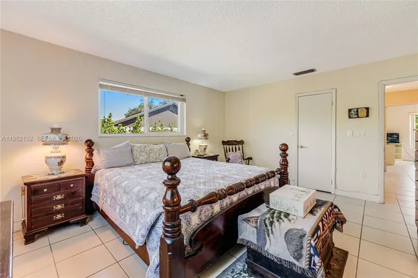a bedroom with a bed and a dresser in it