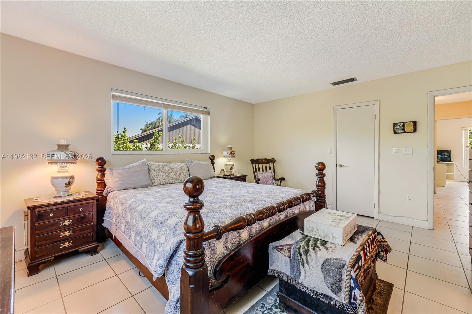 11541 Southwest 100th Street Miami, FL 33176 - Photo 20 of 51 a bedroom with a bed and a dresser in it