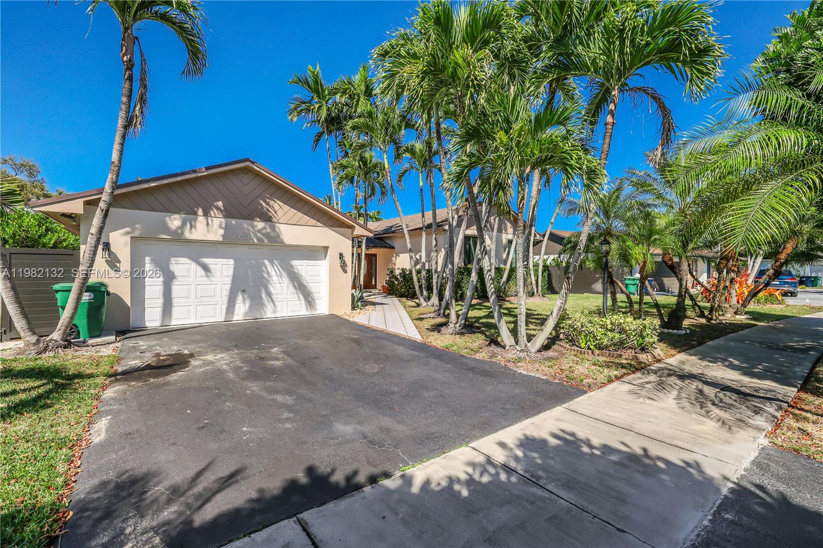 11541 Southwest 100th Street Miami, FL 33176 - Photo 2 of 51 a front view of a house with a yard