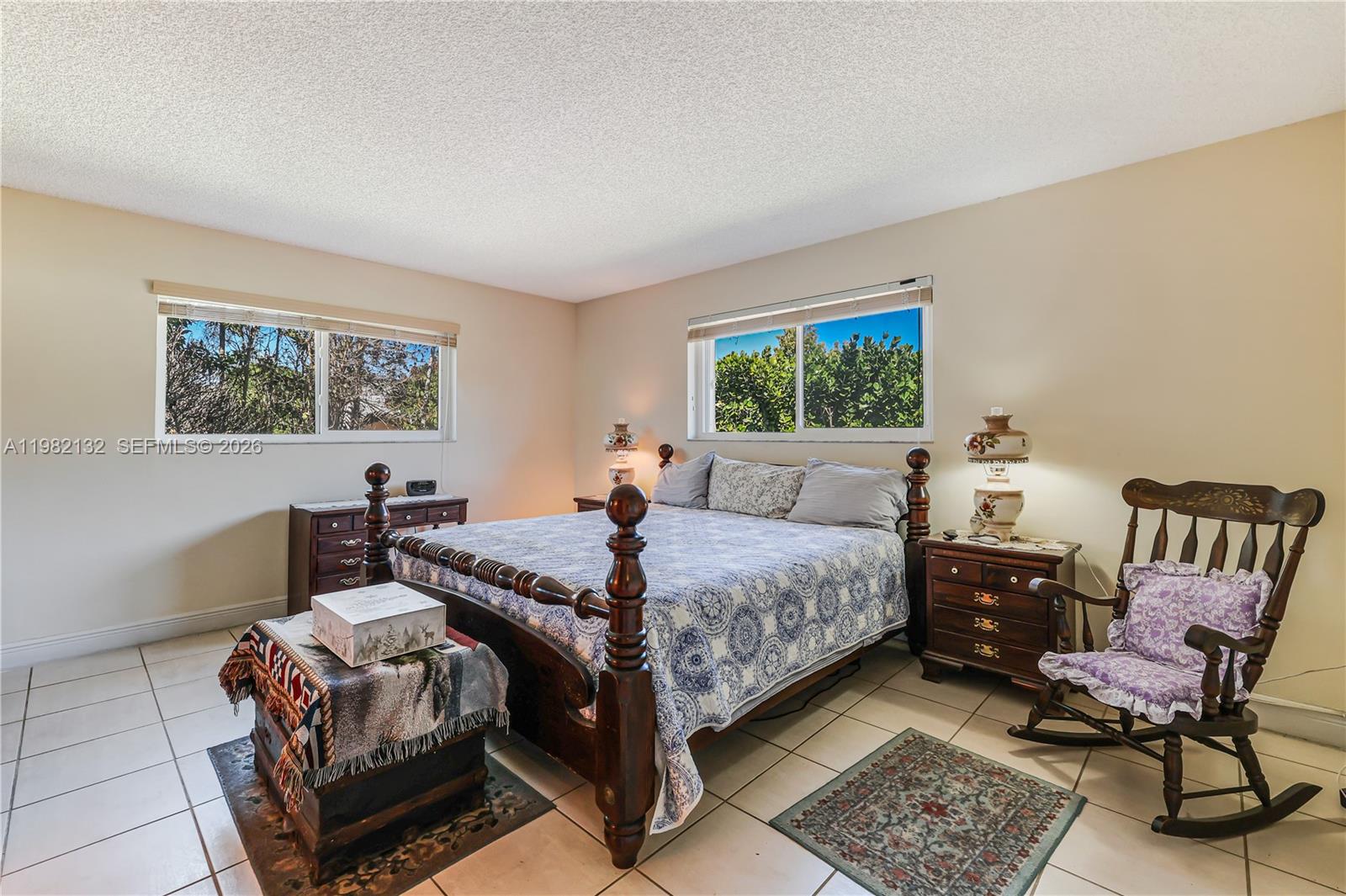11541 Southwest 100th Street Miami, FL 33176 - Photo 21 of 51 a bedroom with a bed a lamp and a window