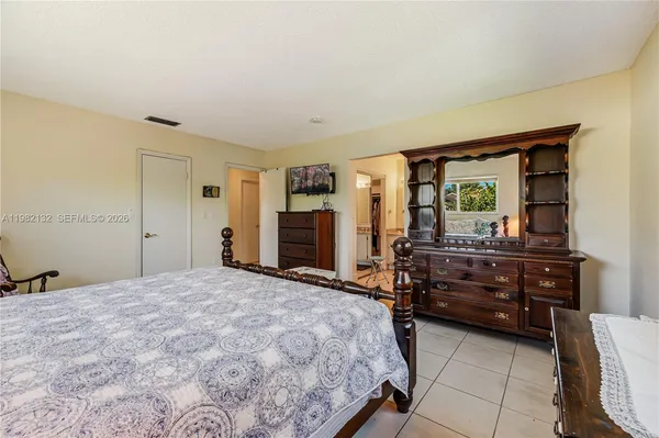 a bedroom with a bed and a dresser