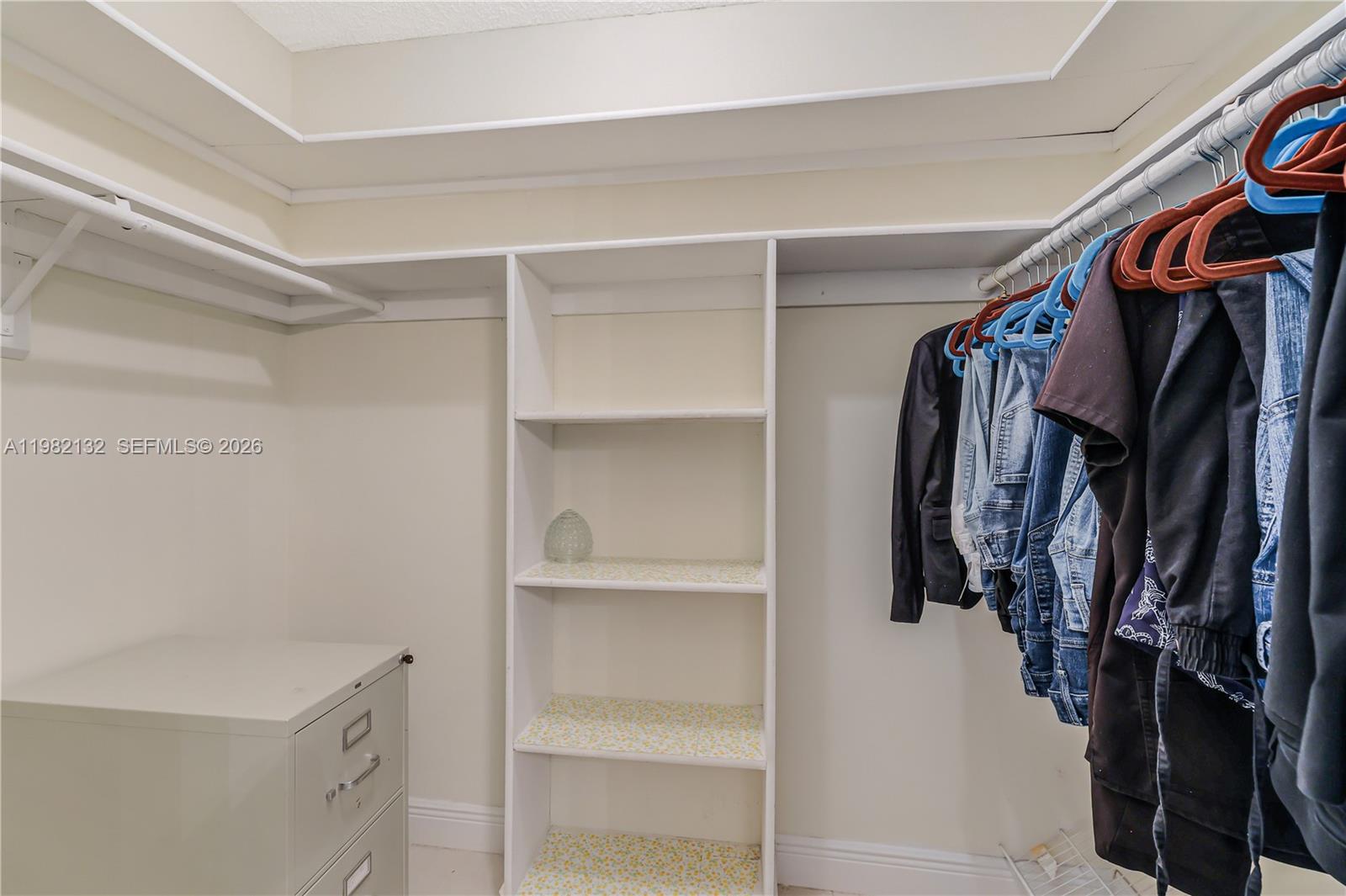 11541 Southwest 100th Street Miami, FL 33176 - Photo 23 of 51 a view of walk in closet with clothes and shoes