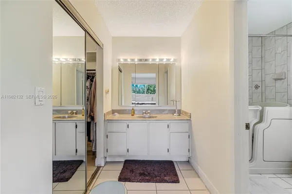 a large bathroom with a granite countertop sink a toilet and shower
