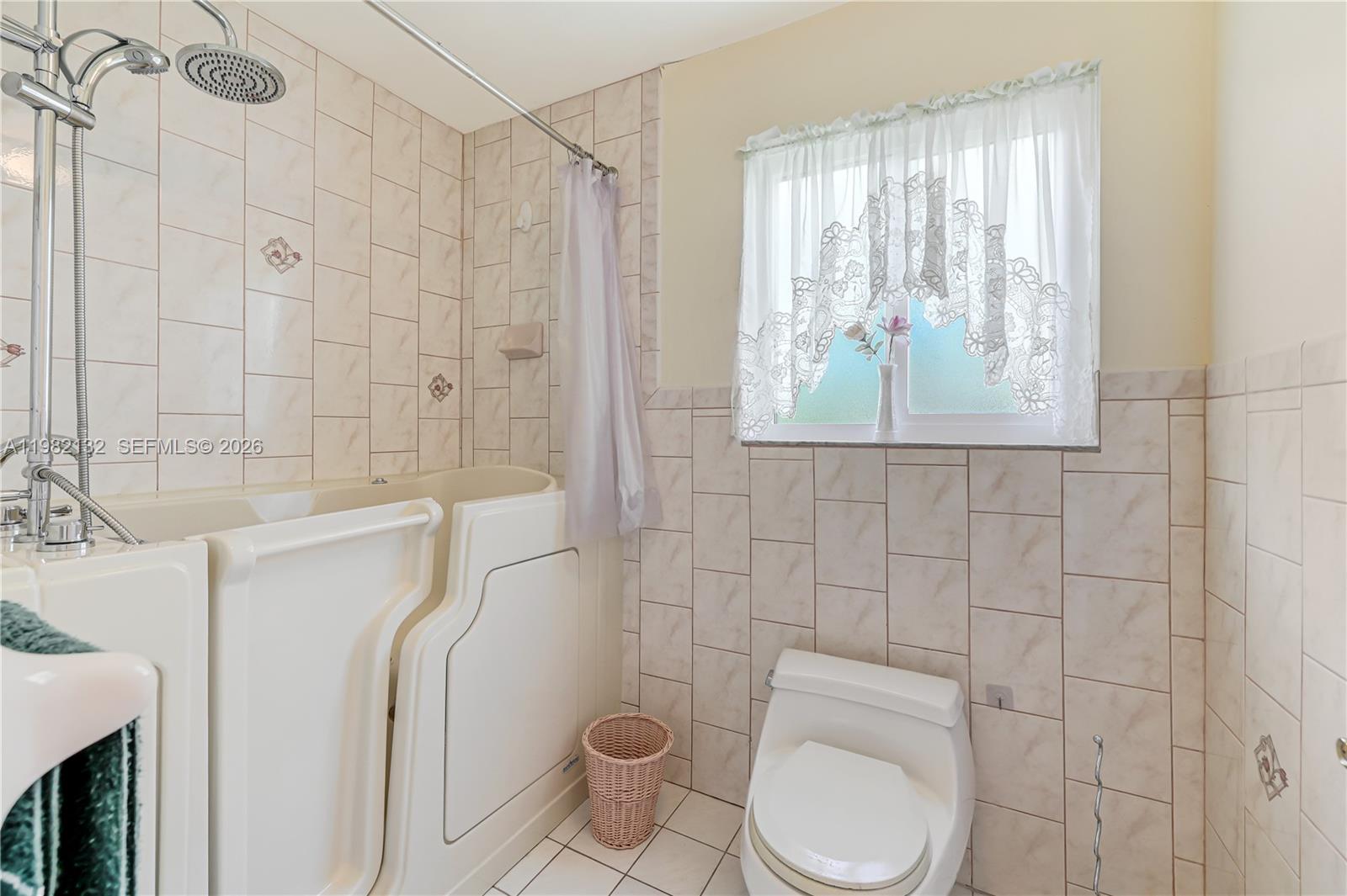 11541 Southwest 100th Street Miami, FL 33176 - Photo 25 of 51 a white toilet sitting next to a bathroom sink