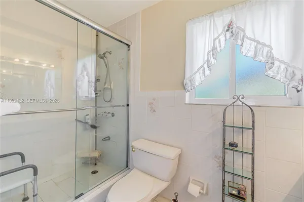 a bathroom with a shower a toilet and a sink