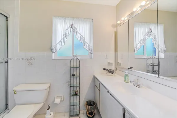 a bathroom with a sink a toilet and vanity