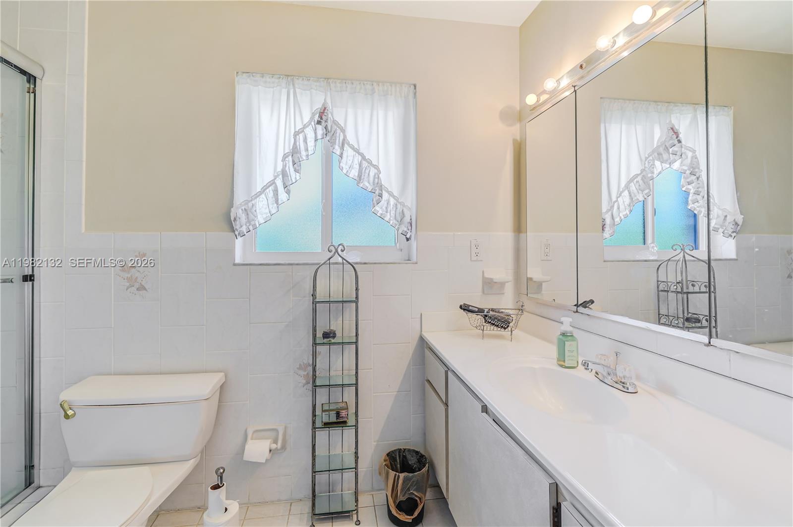 11541 Southwest 100th Street Miami, FL 33176 - Photo 27 of 51 a bathroom with a sink a toilet and vanity