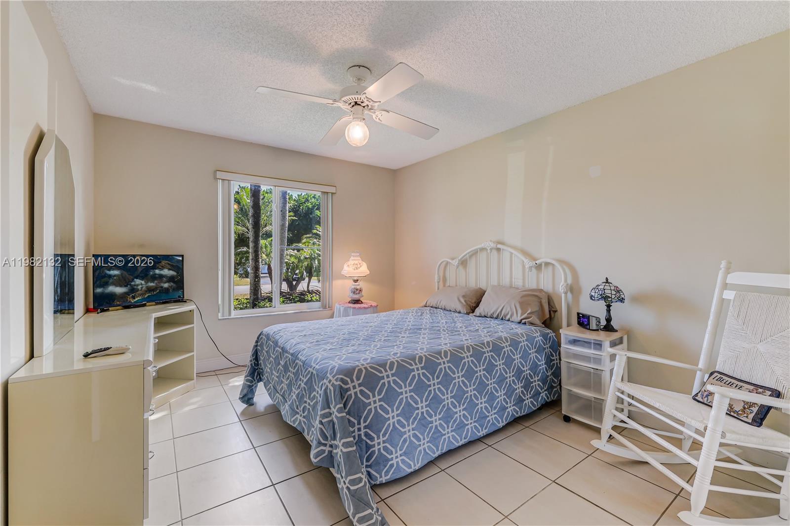 11541 Southwest 100th Street Miami, FL 33176 - Photo 29 of 51 a bedroom with a bed and a flat screen tv