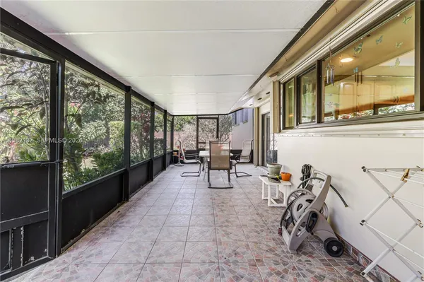 a view of a chairs and table in a balcony