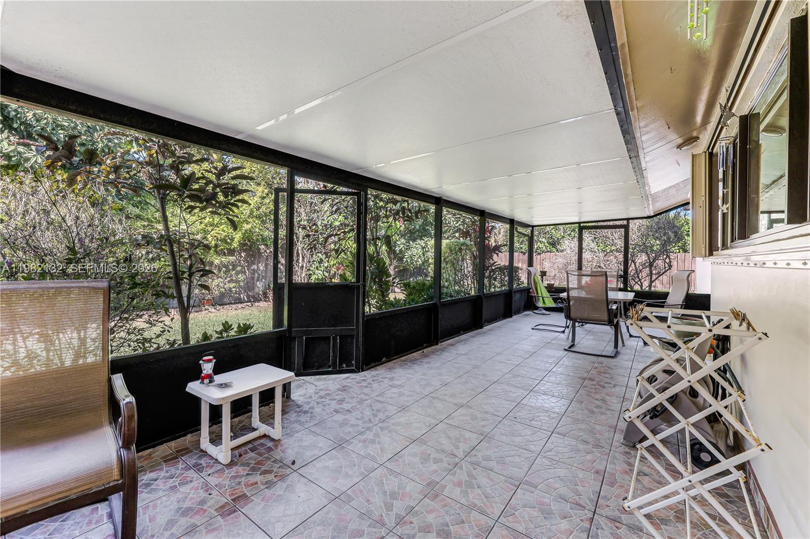 11541 Southwest 100th Street Miami, FL 33176 - Photo 32 of 51 a living room with furniture and a large window