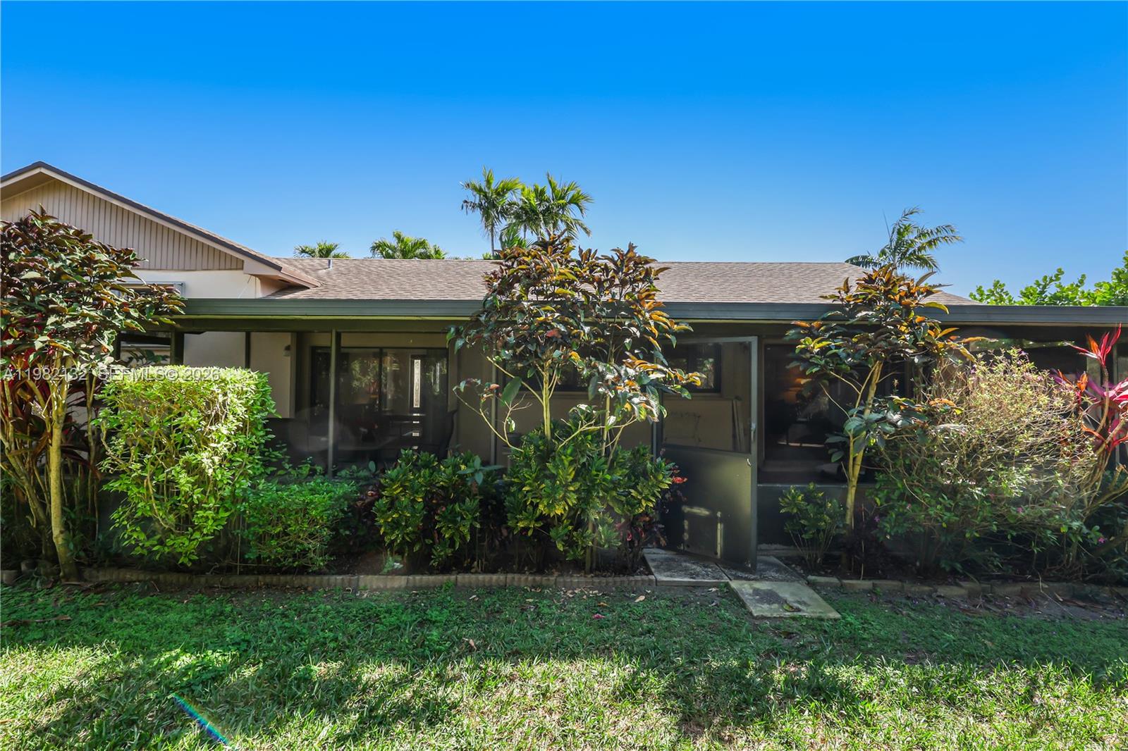 11541 Southwest 100th Street Miami, FL 33176 - Photo 33 of 51 a front view of a house with a garden